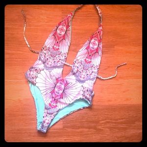 Low cut, bright patterned one piece bathing suit